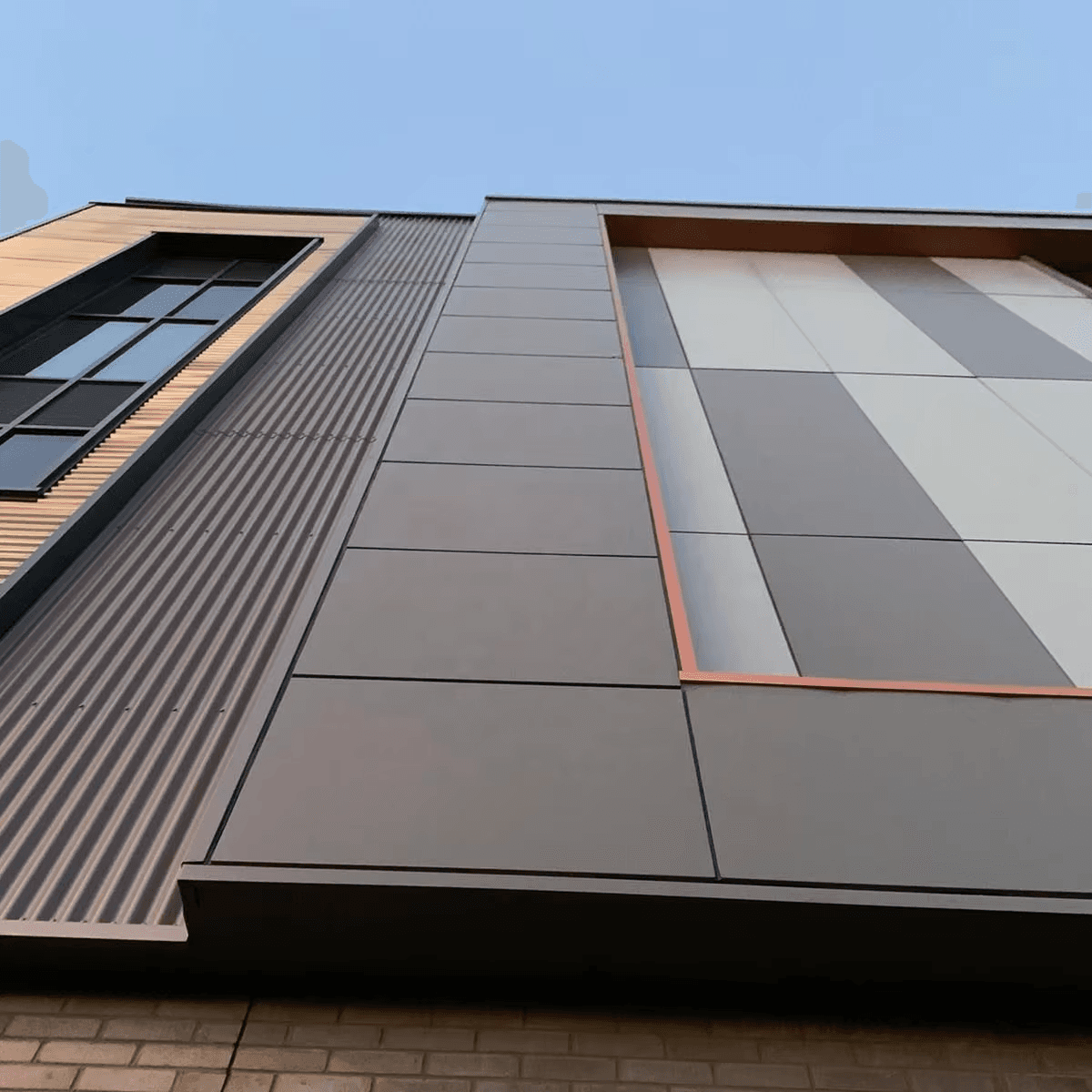 Building facade with grey aluminium composite panel cladding